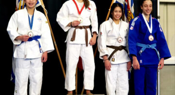 Isla Diesmos of Calgary (extreme left) wins a silver medal
